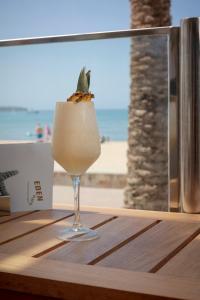 a drink in a glass sitting on a table near the beach at Hotel Eden Palma Playa Adults Only in Can Pastilla +88 photos