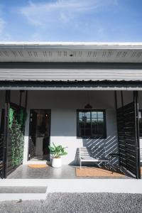a patio with a bench and a house at Sandana Studio Apartments - Studio 2 in Nathon Bay +1 photo