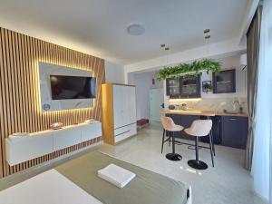 a living room with a kitchen with a table and chairs at Chic 2 Chic Boutique in Bucharest