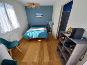 a small bedroom with a bed and a television at Échappée iodée et nature à l'Île d'Oléron in Saint-Georges-dʼOléron