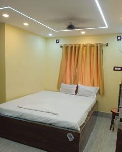 a bed in a room with a curtain at Royal Guest House in Baidyabāti