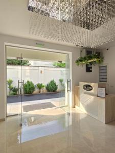 a lobby with a glass door and a building at Chic 2 Chic Boutique in Bucharest