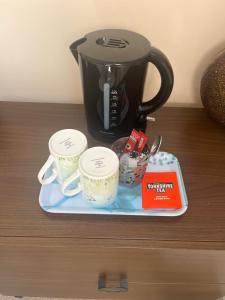 a coffee pot and two cups on a tray at Modern Private Rooms in Chelmsford with Workspace & Free Parking in Chelmsford