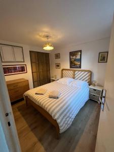 a bedroom with a bed with a striped bedspread at Balea Gorri in Ciboure
