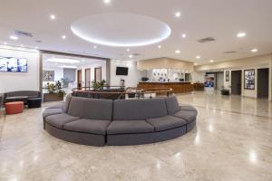 a large lobby with a couch in the middle at Best Western Park Hotel in Piacenza