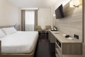 a hotel room with a bed and a desk at Best Western Park Hotel in Piacenza +60 photos