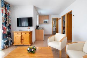 a living room with a couch and a table at MUR Bungalows Parque Romantico in Playa del Ingles