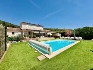 a swimming pool with a slide in a yard at Les Carnoulettes in Carnoules