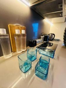 a kitchen counter with four glass containers on it at Supernova luxe heaven in New Delhi +3 photos