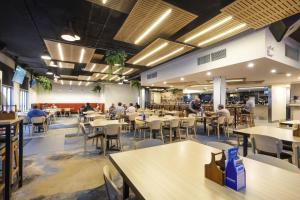 a restaurant with tables and people sitting at tables at Nightcap at the Cavenagh in Darwin