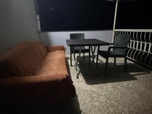 a living room with a couch and a table and chairs at Tsikhisdziri Hotel in Ts'ikhisdziri