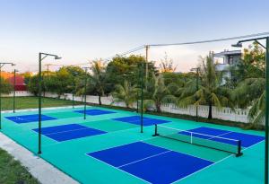 a group of tennis courts in a park at 359 Beach Hotel in Phú Xá