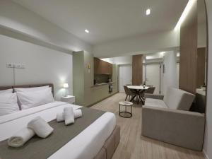 a bedroom with a large bed and a living room at O!live Fully Equipped Apartments with Unique Design in Athens