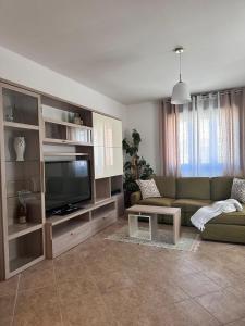 a living room with a couch and a flat screen tv at Panorama Rooms in Gesualdo