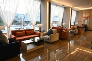 a living room with couches and tables and windows at فندق امان أبها - المعالي in Abha +51 photos