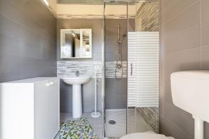 a bathroom with a shower and a sink at Villa Caterina in Solarino +20 photos