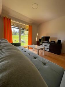 a living room with a couch and a table at Apartmány2 - Náhlov in Frymburk