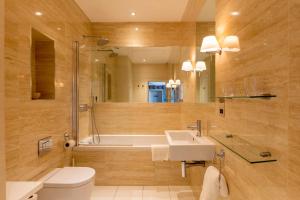 a bathroom with a tub and a sink and a toilet at St Michael's Manor Hotel - St Albans in St. Albans +52 photos