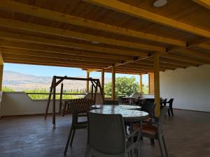 a patio with tables and chairs and a view at Gross Nofesh and Spa Guesthouse in Beit Hillel