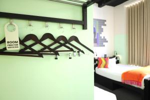 a bedroom with a bed with a sign on the wall at Garner Hotel Dublin Temple Bar by IHG in Dublin