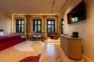 a living room with a red couch and some windows at Casa Di Paolo in Sibiu