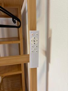 a remote control is attached to a wooden door at Modern Apartment 2 Graf - New!! in Grafenwöhr