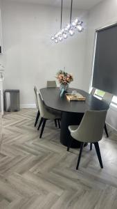 a dining room with a black table and chairs at Ballarat home in Ballarat +8 photos