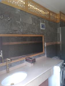 a bathroom with a sink and a mirror at Guest House in Luxor