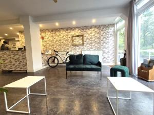 a living room with a black couch and a brick wall at Balea Hostel in San Sebastián
