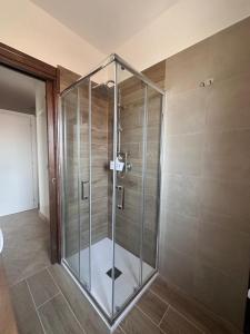 a shower with a glass door in a bathroom at Panorama Rooms in Gesualdo +46 photos