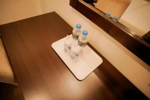 two bottles of water sitting on a table at Hotel New Indraprastha in Adūr
