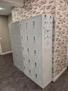 a bunch of lockers are lined up against a brick wall at Balea Hostel in San Sebastián