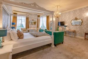 a bedroom with a bed and a living room at St Michael's Manor Hotel - St Albans in St. Albans