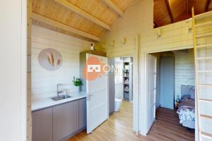 a bathroom in a tiny house with a sink and a toilet at B&B Sint Andries in Koewacht