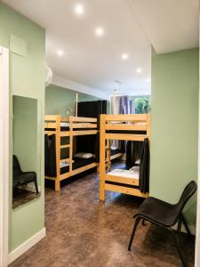 a room with two bunk beds and a chair at Balea Hostel in San Sebastián