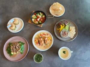 a table with plates of food and bowls of food at The SENSE FUJI in Narusawa