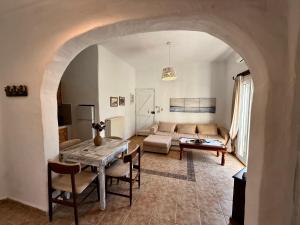 a living room with a table and a couch at Atlazia Suites in Alinda