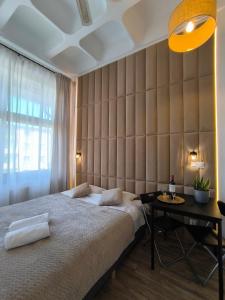 a bedroom with a large bed and a table at Place4You Studio w Sercu Ostródy in Ostróda +17 photos