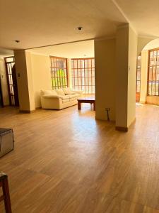 an empty living room with a couch and a table at Rolys House in Los Baños del Inca