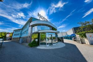 a building with a sign on top of it at Hotel Vaka in Brno