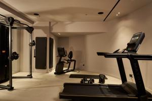 a gym with a treadmill and two exercise bikes at The Fiction in Athens