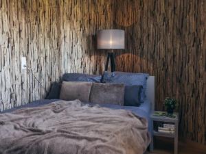 a bedroom with a bed and a table with a lamp at Apartment Hainich in Mühlhausen