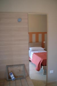 a bedroom with a bed and a mirror in a room at Bruner Haus - Casa Vacanze in Castelmezzano