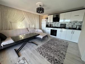 a living room with a couch and a table at Mavi Apart in Demre