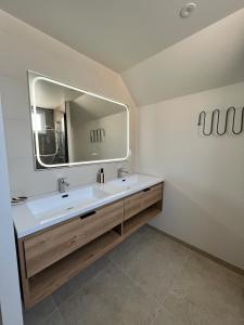 a bathroom with a sink and a mirror at Maison Hyper-centre Dinard - Garage privé - 200 M plage in Dinard