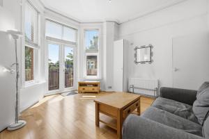 a living room with a couch and a table at Madeley Oak in Ealing