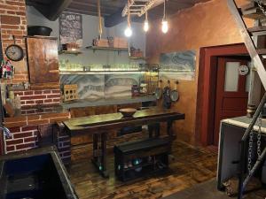 a kitchen with a wooden table in a room at Chata LEA in Ratkovské Bystré +26 photos