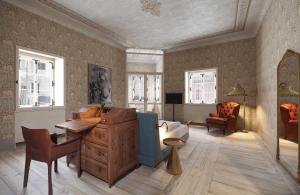 a living room with a desk and a chair at Langenmantel Historic Suites in Termeno