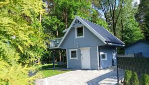 a tiny house in the middle of a forest at Domki Przydwórz in Przydwórz