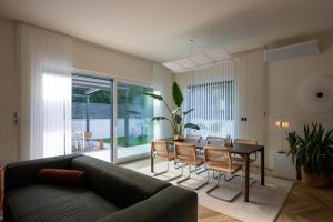 a living room with a couch and a table at Casa Palmera in Pridraga